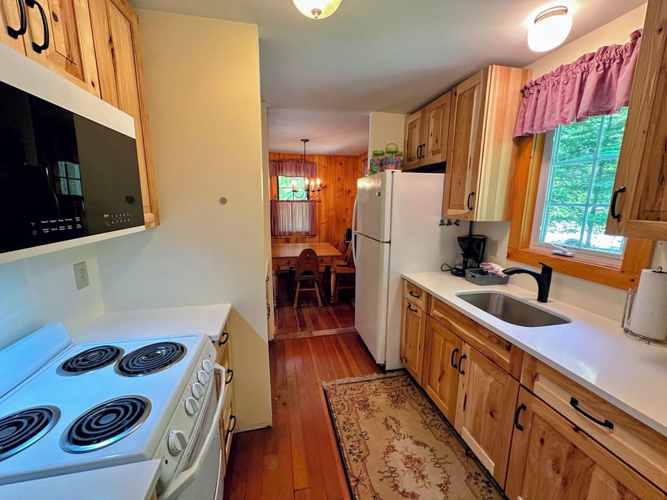 Galley kitchen with drip coffee maker, fridge/freezer, range and microwave