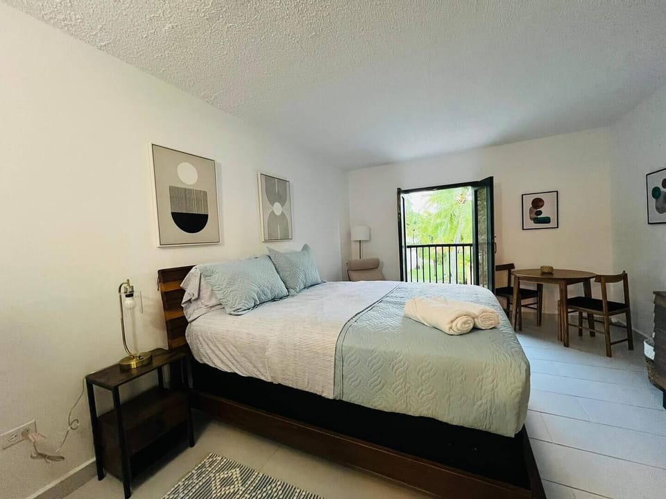 The bedroom has a queen size bed, smart TV and a sitting area to sit and relax.