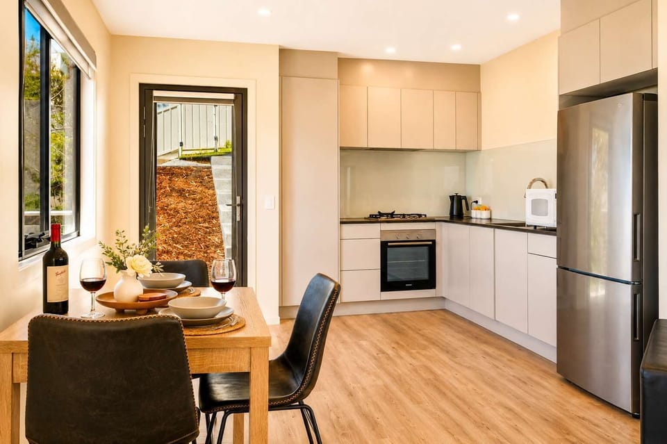 Modern open-plan studio living with lounge, dining and a fully equipped kitchen for an easy, comfortable stay.