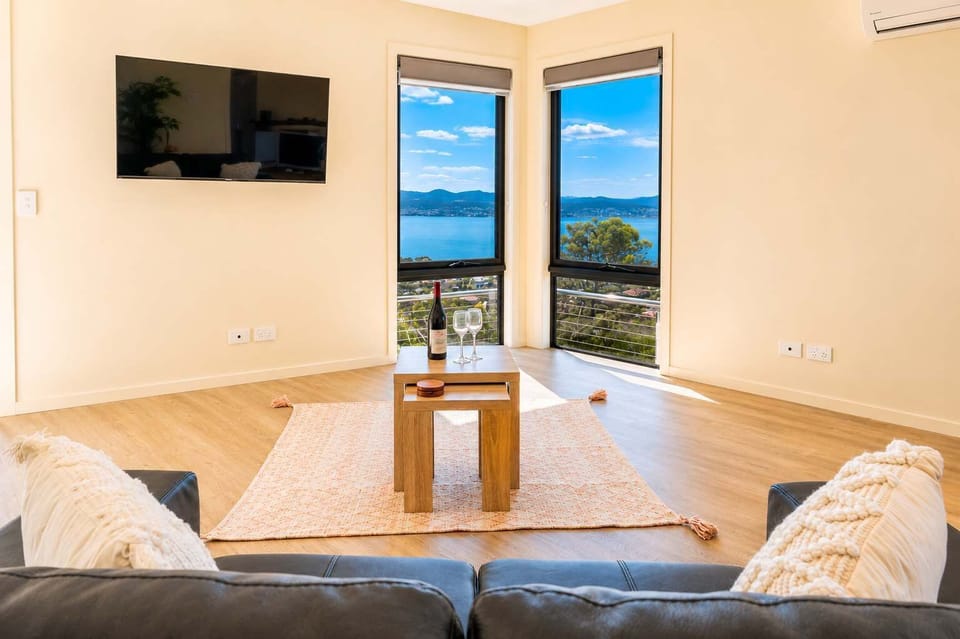 Relax in the light-filled living space with Smart TV, comfortable seating and water views just outside.