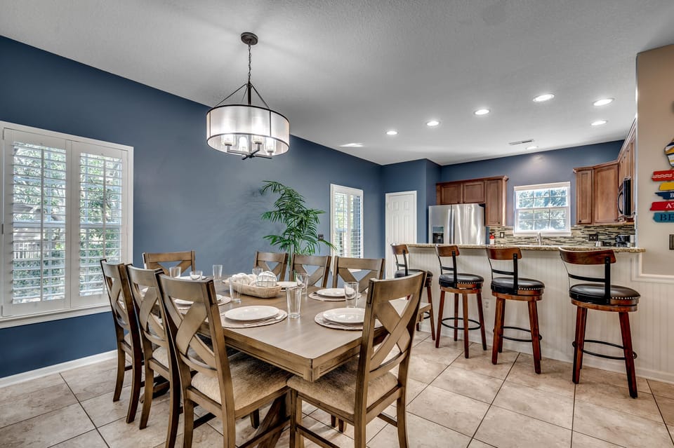 From the cozy living space, behold the heart of our beach haven—the table for 8, bar seating for 4, and a fully stocked kitchen, all seamlessly connected. It's not just a meal; it's a coastal experience where every bite comes with a side of relaxation. 