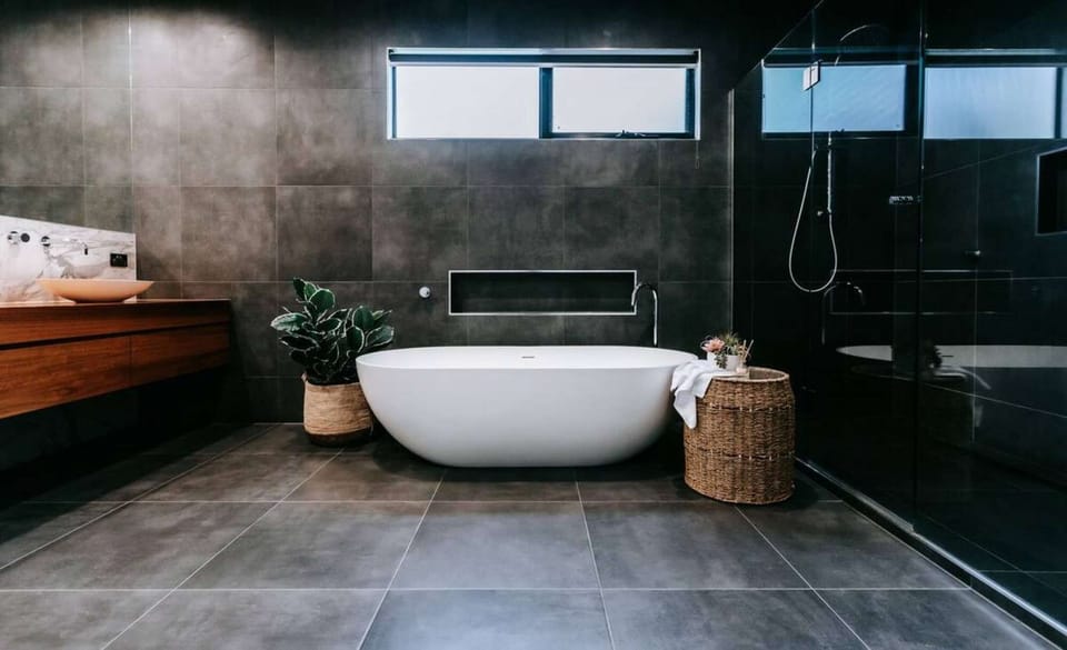 Ensuite bathtoom with bath, twin showers and vanity_