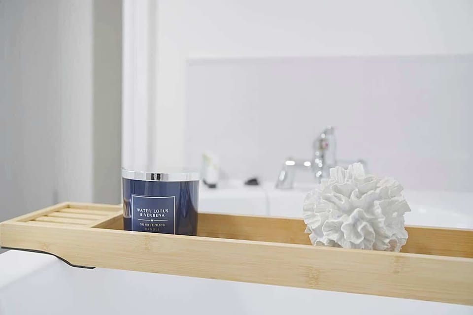 The bathroom benefits from a bath, an overhead shower, toilet and a sink. 