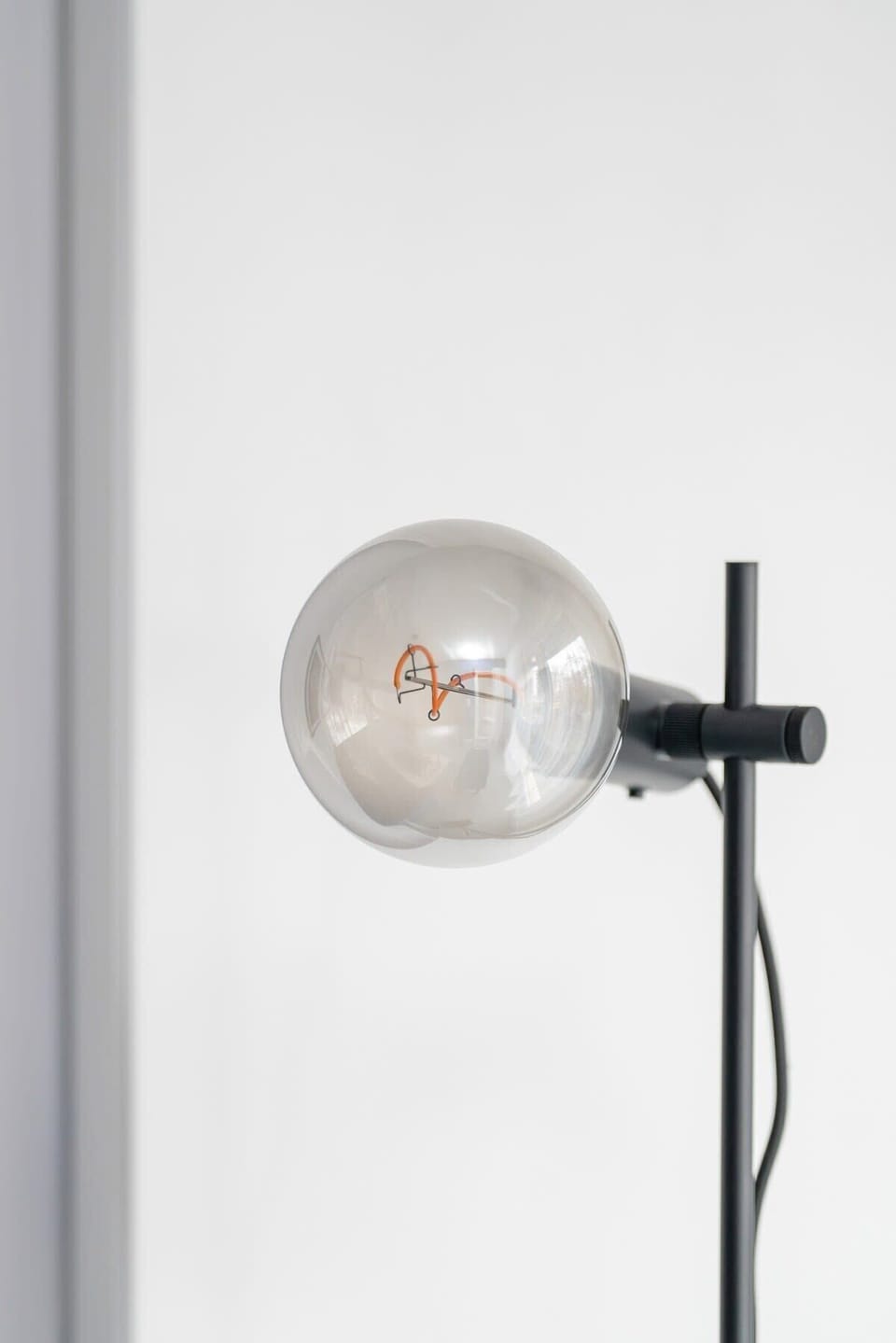 A close-up of a modern wall light fixture with a minimalist design, enhancing the room's elegant decor.

