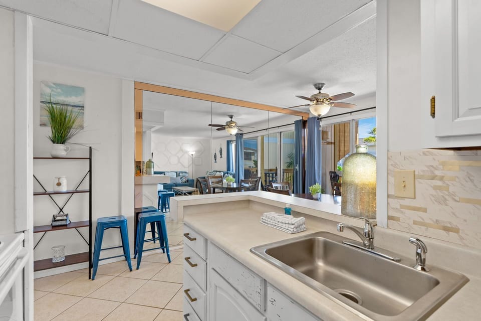 Step into a bright coastal kitchen with modern conveniences and open sightlines to your inviting living area, where breezy views and relaxed island touches welcome you home.