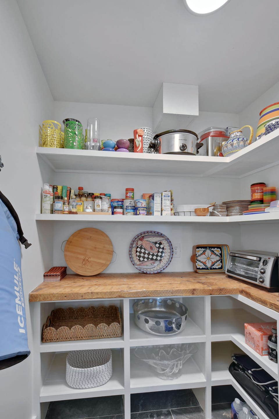 Styled Pantry Shelves - Open shelving keeps kitchen extras, serving pieces, and coffee items within easy reach.