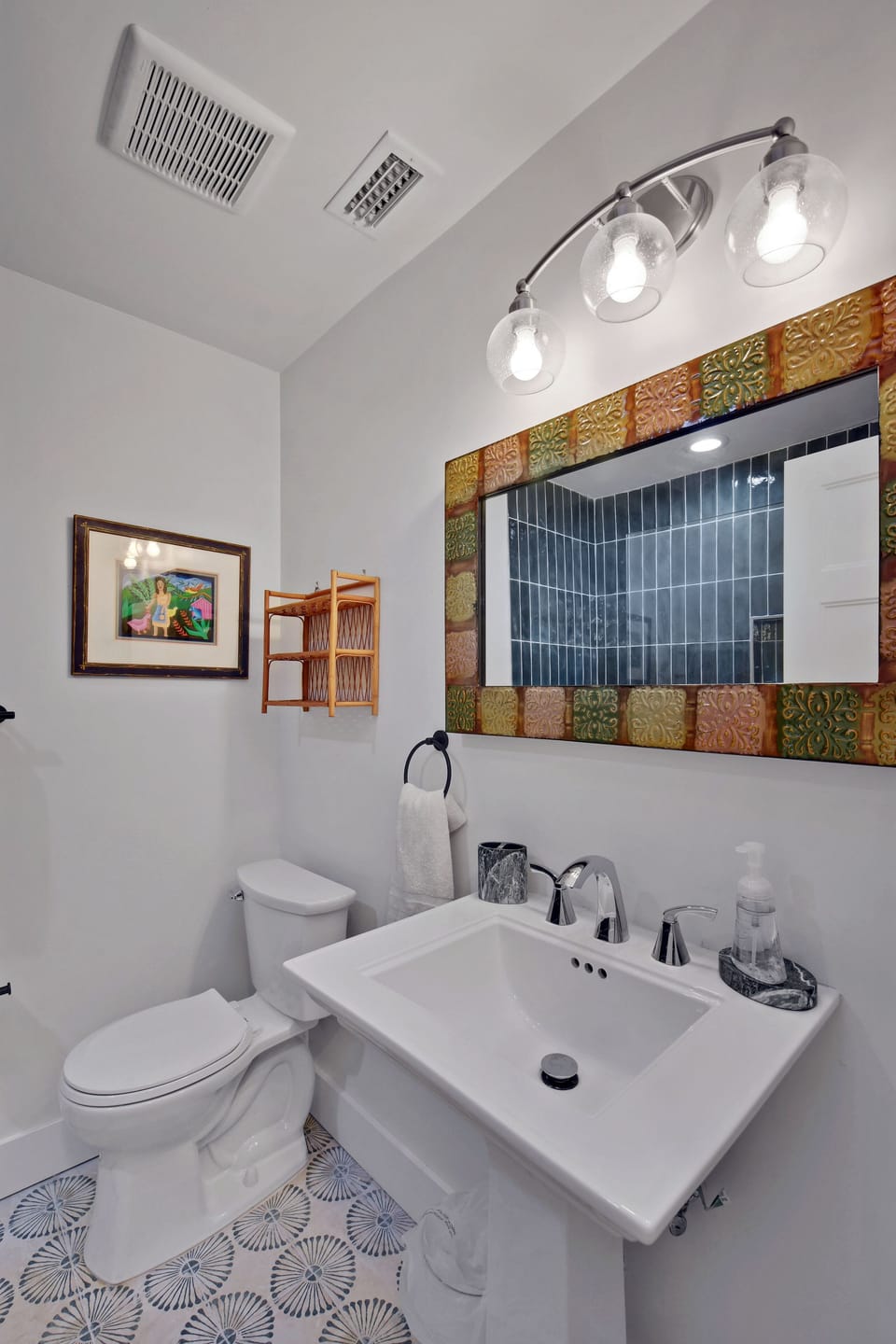 Shared Hall Bath with Blue Tile - Vanity, tub-shower, and glass shelving serve the Blue Room and Orange Room.