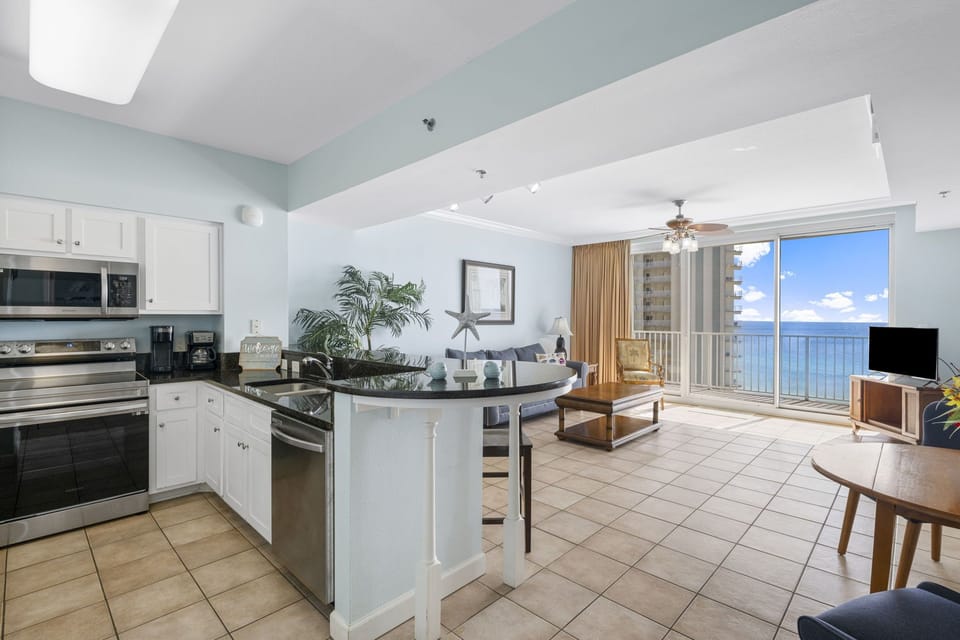 Open kitchen and living area with ocean views and natural light