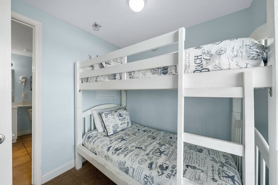 Cozy bunk bed setup in a softly painted room perfect for family stays.