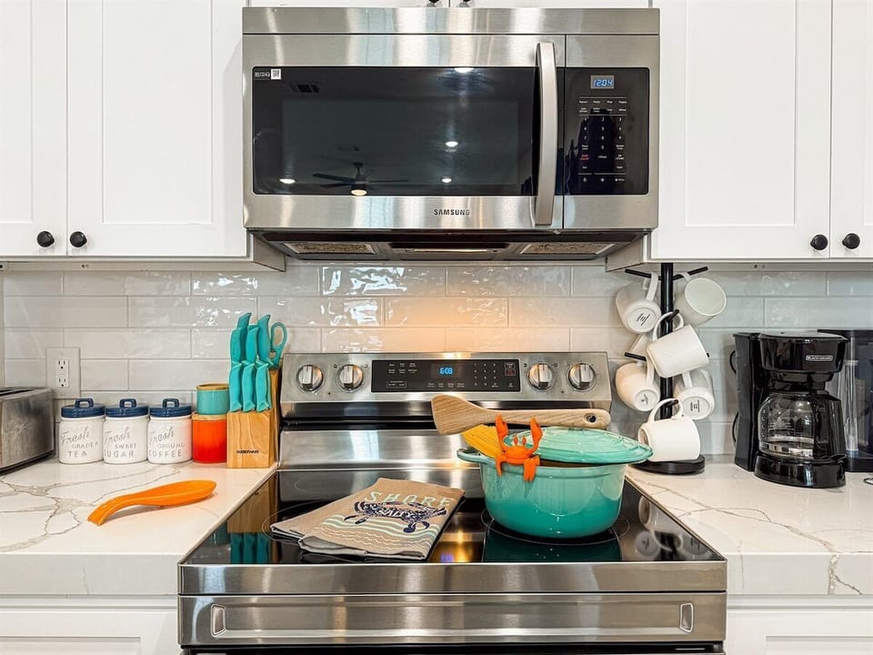 The fully stocked kitchen has stainless steel appliances.