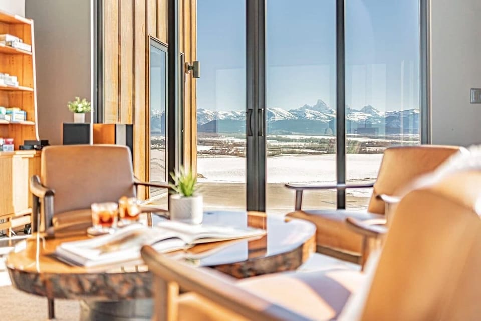 Every room is greeted by views of the Tetons, including this space used for lounging, reading, or playing games. 