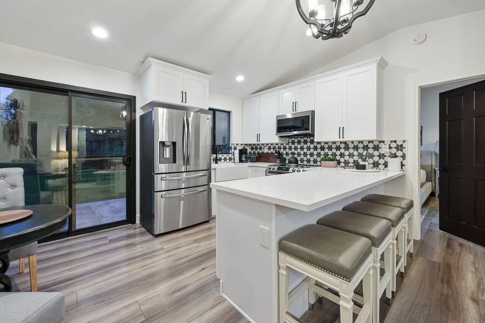 Kitchen with bar stool seating for 4 and sliding door to the backyard