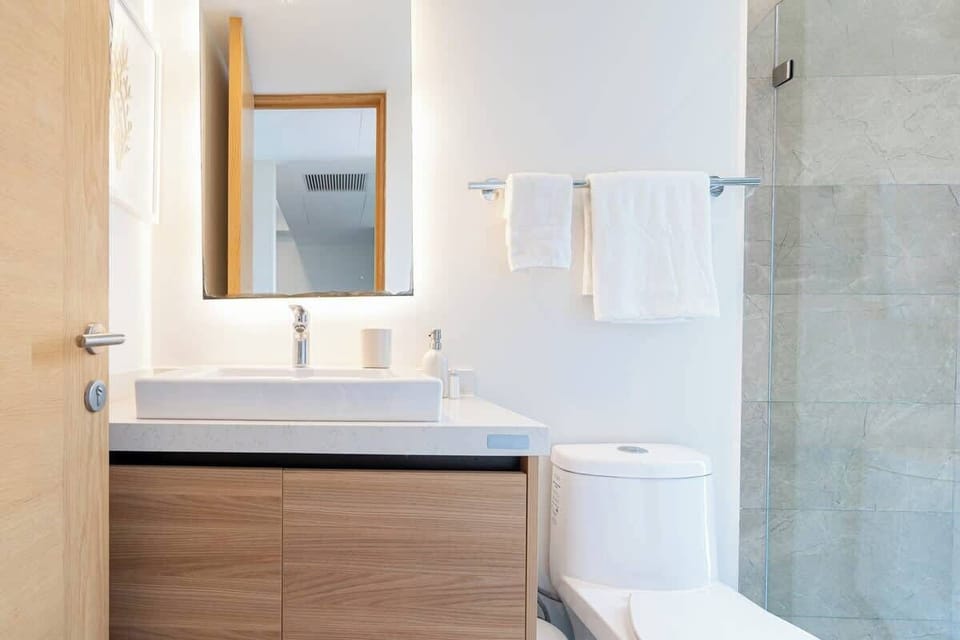 Modern bathroom with quality finishes and good lighting.