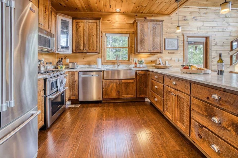 Dual oven, farmhouse sink, new dishwasher, and side by side refrigerator
