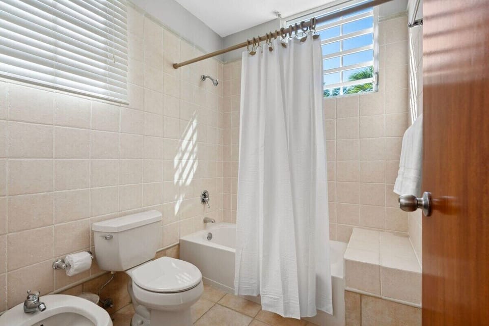 The master bathroom has double sink and tub with shower.