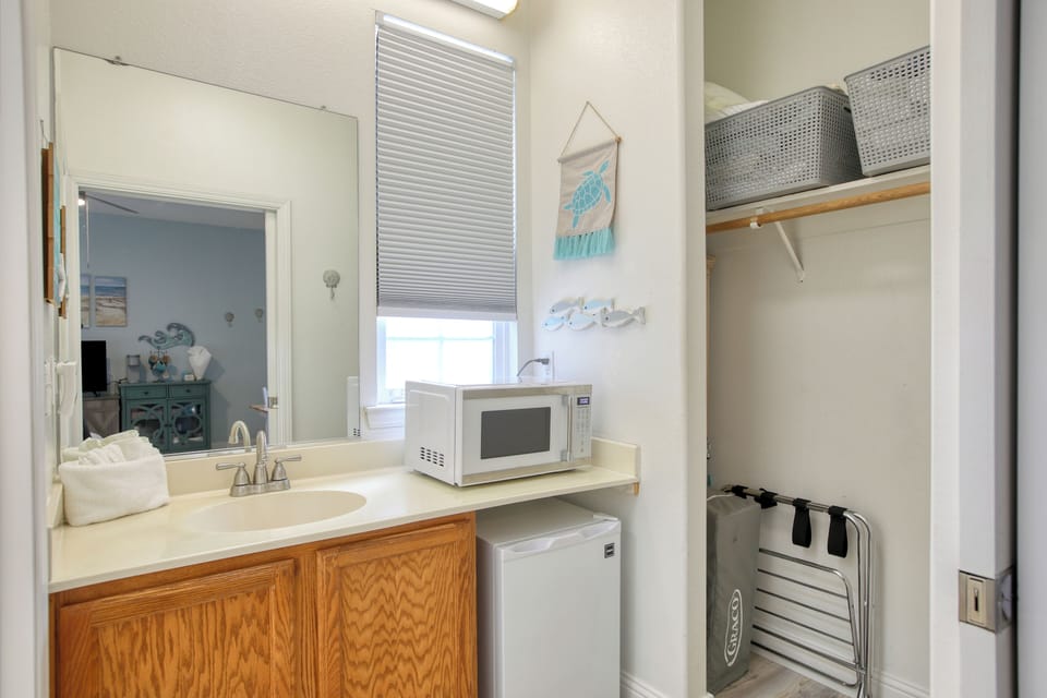 Compact kitchenette has a mini fridge, microwave, and kcup coffee maker—perfect for quick beachside bites.