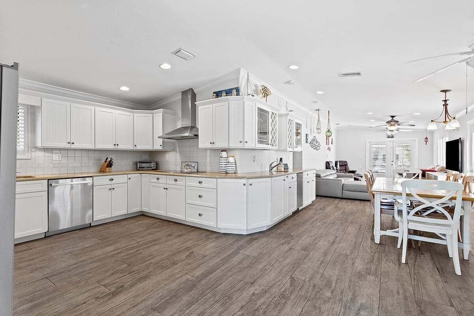 Crisp white cabinetry, abundant counter space, and an open layout make cooking and gathering effortless.