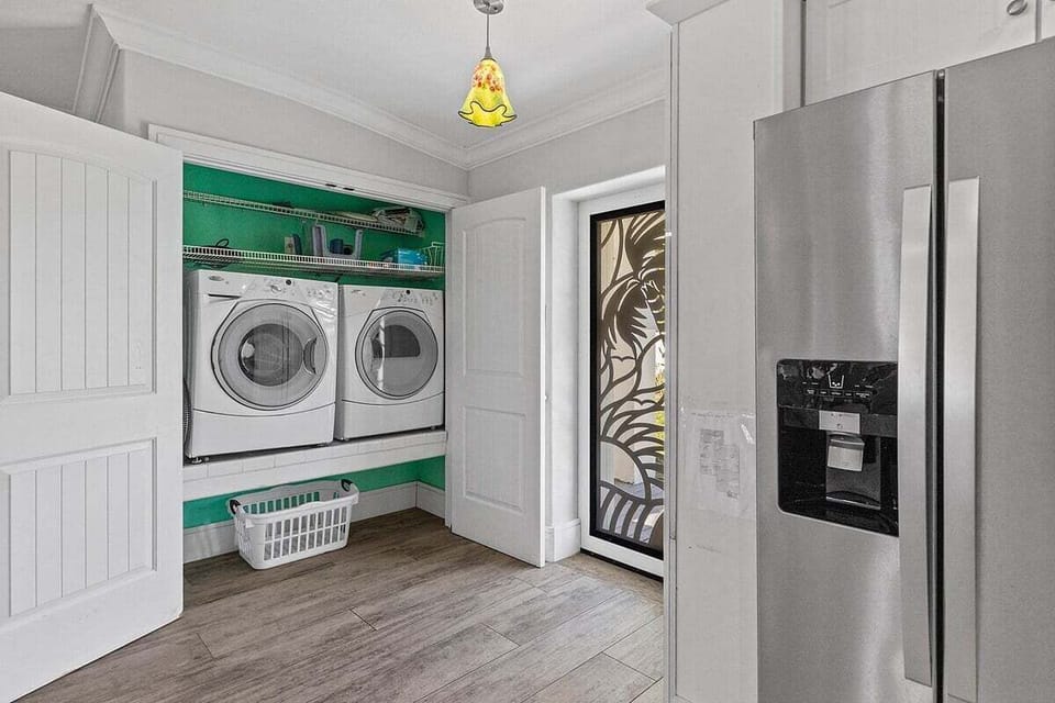 Washer, dryer, and extra storage are thoughtfully tucked away for added convenience.