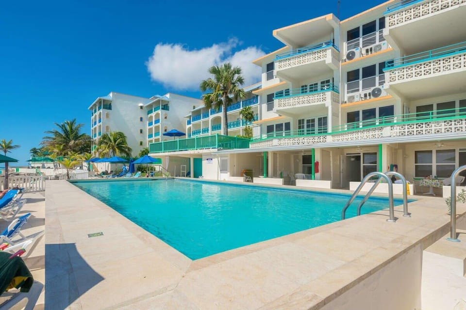 Lounge by the sparkling pool with tropical vibes all around.