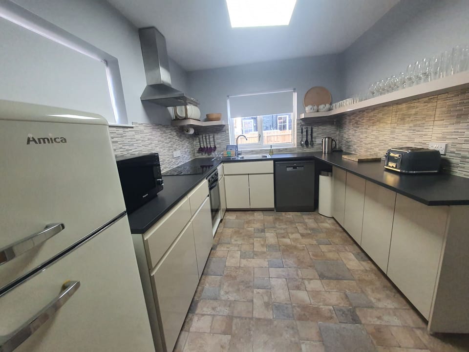 The kitchen comes equipped with fridge/freezer, electric oven and hob, dishwasher and microwave