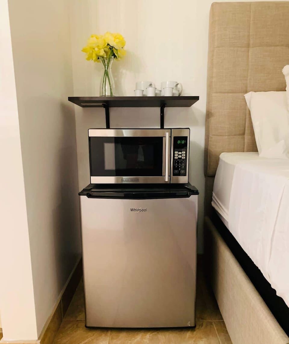 Enjoy the convenience of a mini-fridge and microwave, perfect for quick snacks and refreshments.