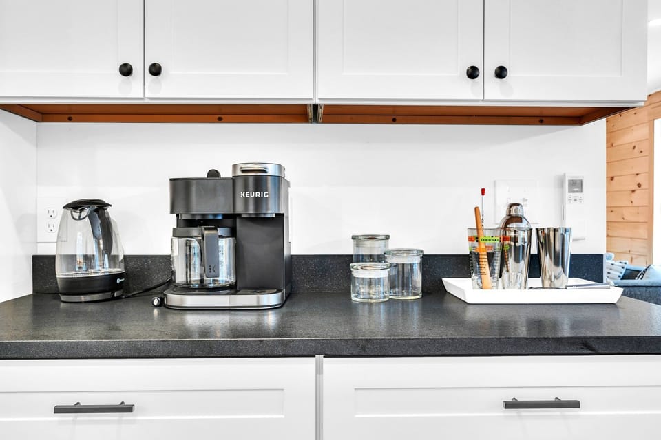 A kettle, a Keurig, and a cocktail shaker to make the beverage of your choice! 