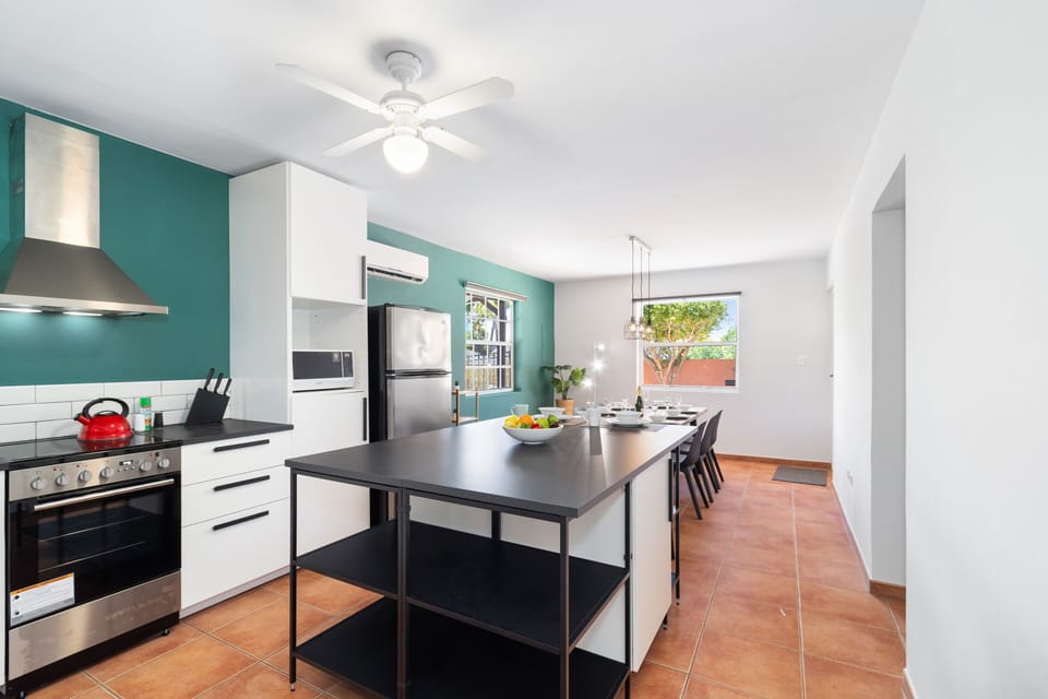 Polished Kitchen of the 3BR House in Noord Aruba - Fully Equipped - Stainless Steel Appliances and clutter-free counters - Smart use of space with versatile storage solutions - Thoughtful placement of kitchen essentials for easy access