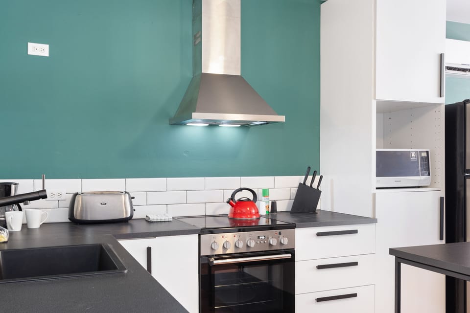 Well-Designed Kitchen of the 3BR House in Noord Aruba - Integrated appliances for a seamless and stylish appearance - Thoughtful placement of kitchen essentials for easy access - Coordinated kitchen decor for a polished and inviting atmosphere