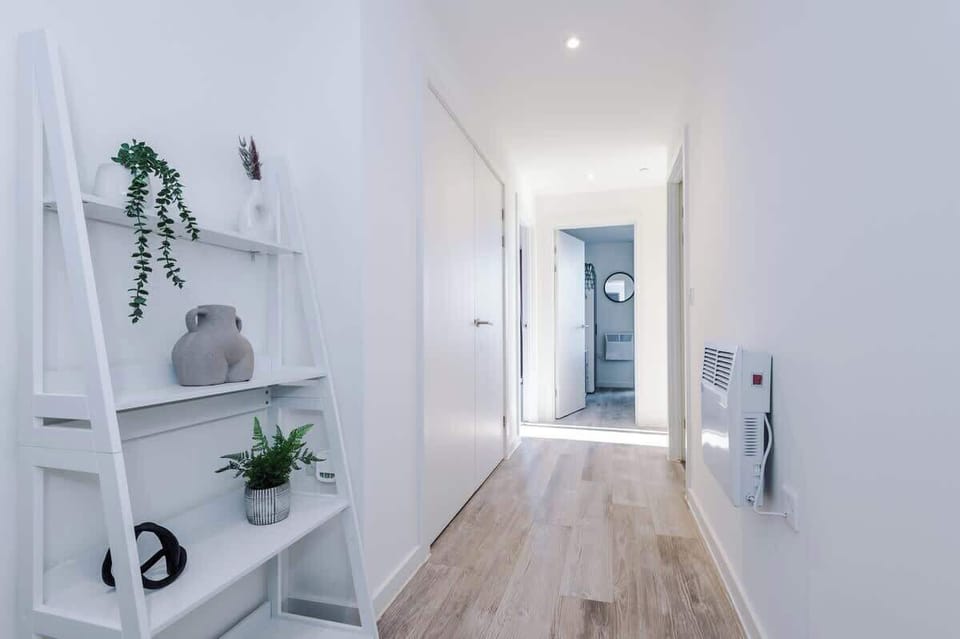 The entrance hallway leads to both bedrooms, the main bathroom and the open-plan living area.