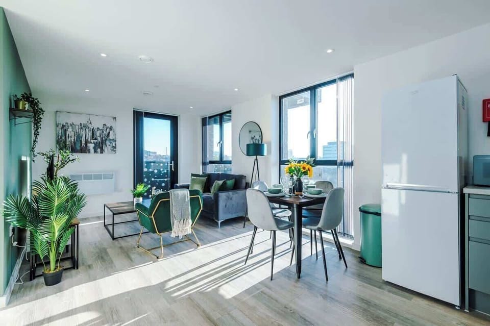 The open-plan living room, dining area and kitchen benefit from a 50-inch Smart TV, a 4-seater dining table, plenty of space to sit down in the evenings and a sizable wrap-around balcony.