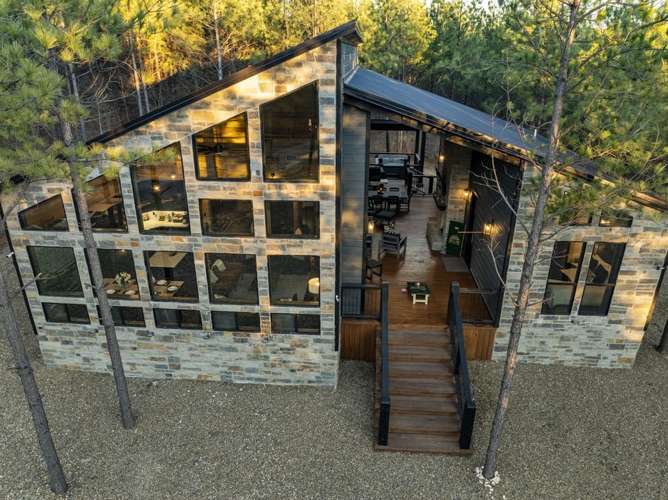 Aerial view of the expansive floor-to-ceiling windows of Alpenglow cabin and the unique breezeway layout that affords the perfect blend of privacy and togetherness