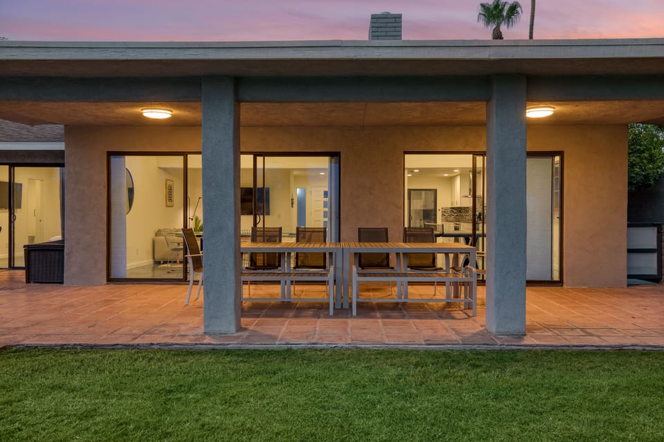 Spacious outdoor dining table features bench seating.