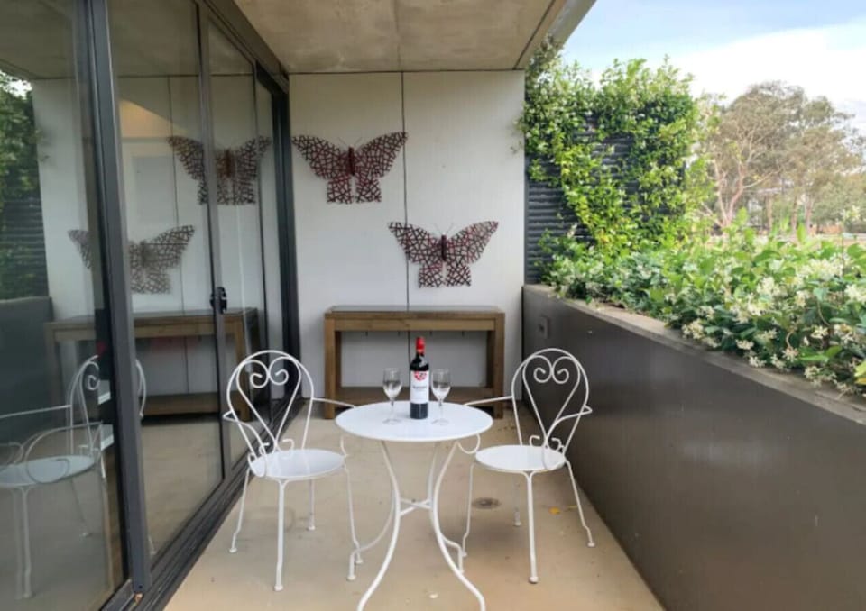 Balcony with table and chairs where you can sit, have your coffee, have some sunlight, and have some fresh air while appreciating the breathtaking view outside.