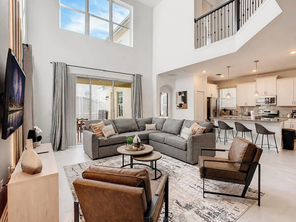 Bright Open Living Room with High Ceilings and Sectional Sofa