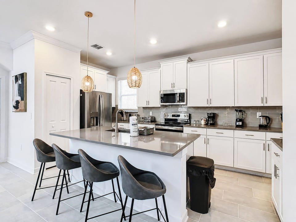 Modern kitchen with island breakfast bar and stainless appliances