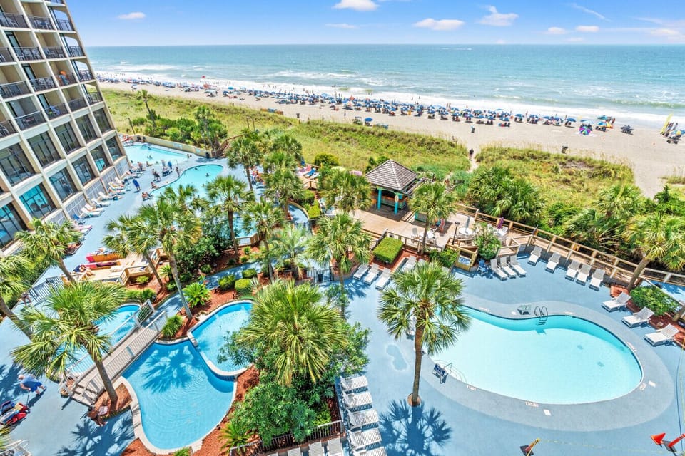 Beach Cove Tropically Themed Resort and North Myrtle Beach Shoreline - Features, pools, hot tubs, decorative fountains that illuminate the night, and lazy river.  Pools and Lazy River are heated for year round enjoyment.