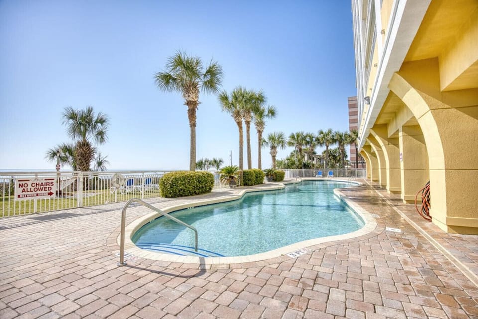 Stylish outdoor pool at Camelot by the Sea, seasonally heated and just steps from the Myrtle Beach oceanfront. Guests can relax poolside and enjoy the seasonal beach bar serving refreshing drinks under the South Carolina sun.