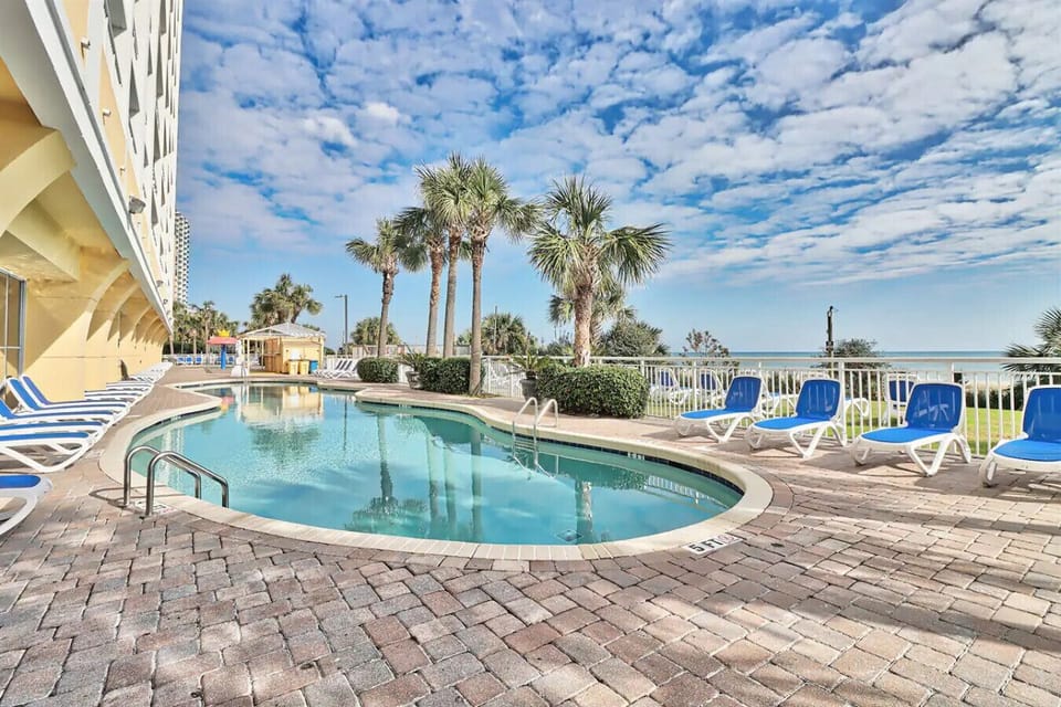 Seasonally heated outdoor pool at Camelot Resort Myrtle Beach with ocean views, direct beach access, and a seasonal poolside beach bar for the ultimate coastal vacation experience.