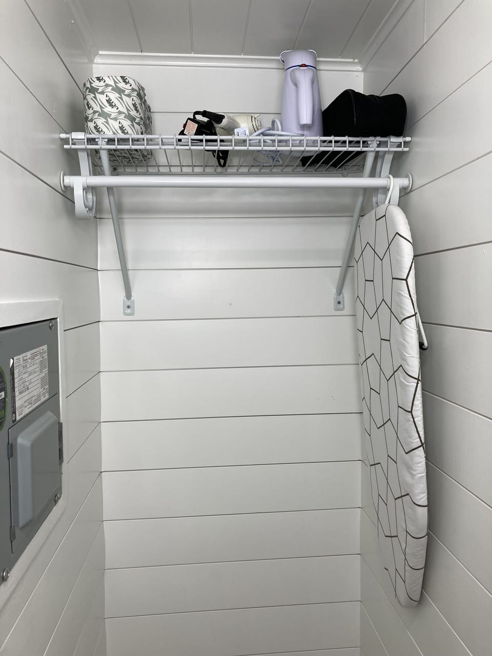 fully stocked closet with iron and steamer and board