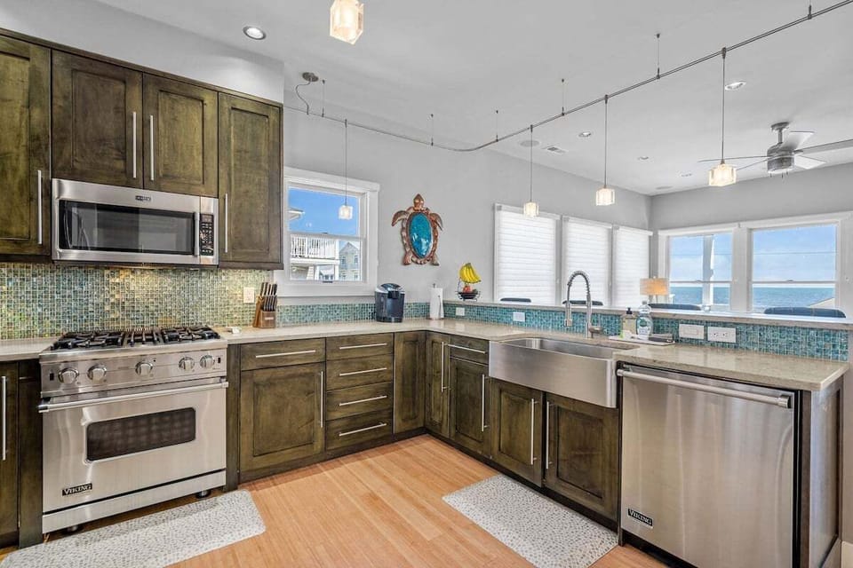 Cook like you're at home in this modern, fully stocked kitchen featuring updated appliances, cookware, spices, and a blender