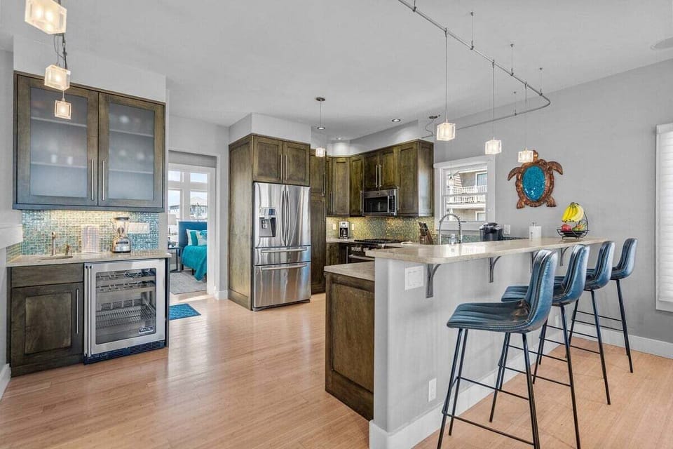 Cook like you're at home in this modern, fully stocked kitchen featuring updated appliances, cookware, spices, and a blender
