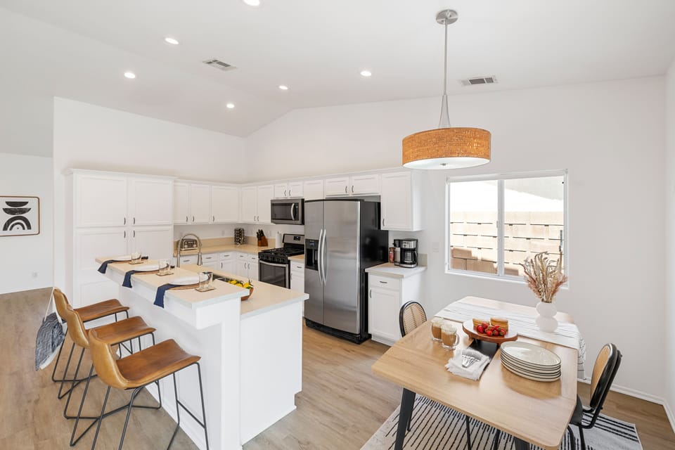 Fully-equipped kitchen with a breakfast bar and modern appliances.