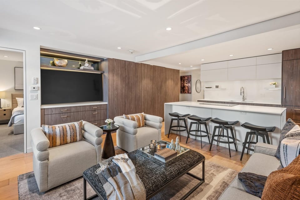 Living area featuring updated, contemporary furniture, smart T.V. and built-in closets