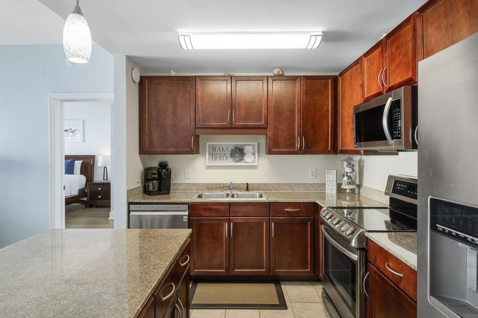 Modern kitchen with stainless steel appliances and dark wood cabinets