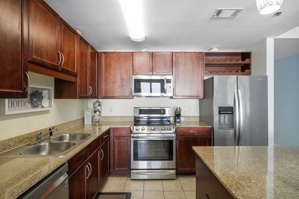 Modern kitchen with stainless steel appliances and granite countertops