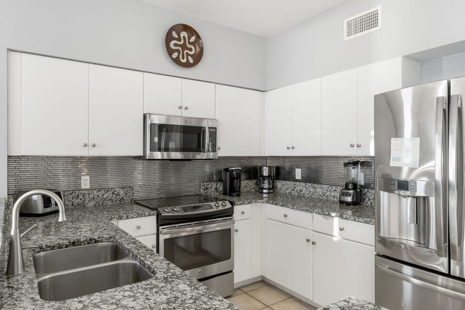 Modern kitchen with stainless steel appliances and granite countertops