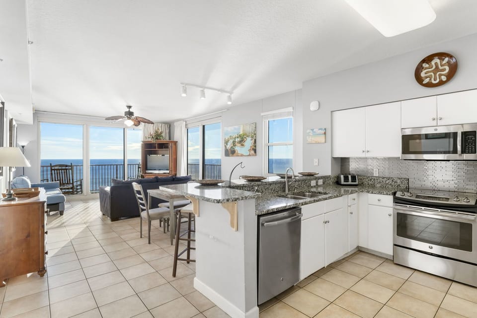 Modern kitchen and living area with ocean views and natural light