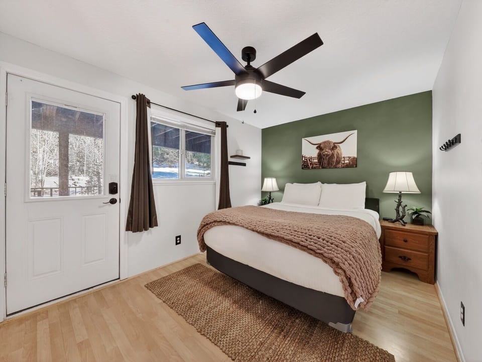 Slip into soft linens and rustic charm in your cozy bedroom, where warm textures and peaceful mountain views create the perfect retreat.