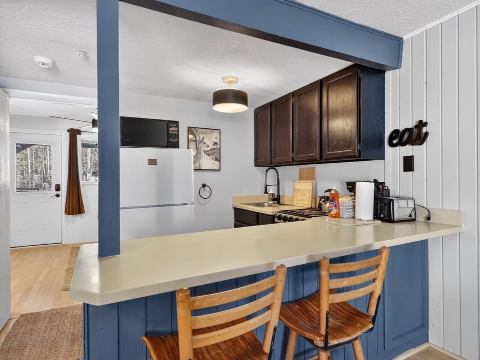 Your open-concept kitchen offers everything needed for memorable meals, from morning coffee at the breakfast bar to family dinners.