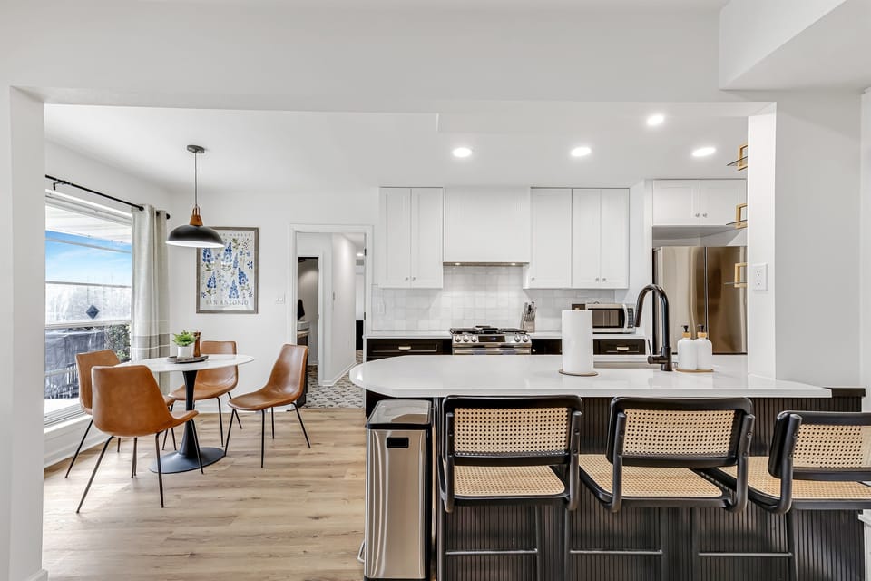 A bright, airy kitchen with sleek finishes and a cozy breakfast nook, blending functionality with modern design.